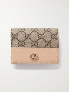 Gucci's wallet is made from durable textured-leather with a signature coated-canvas outer, so it will easily withstand constant use and survive knocks and scrapes in the bottom of your bag. Topped with a tonal logo plaque, it's fitted with five card slots and a zipped compartment to secure coins. Brown Gucci Wallets With Interior Card Slots, Gucci Brown Wallets With Interior Card Slots, Gucci Travel Wallets With Card Slots, Gucci Wallets With Card Slots For Travel, Designer Beige Leather Wallets, Rectangular Gucci Wallet For Travel, Gucci Brown Formal Wallet, Designer Bifold Travel Wallet, Luxury Beige Wallet For Daily Use