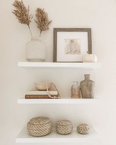 three white shelves with decorative items on them