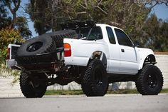 a white pick up truck parked on the side of a road