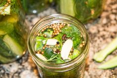 a mason jar filled with green vegetables and other things on top of a granite counter