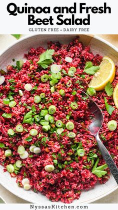 quinoa and fresh beet salad in a bowl with lemon wedges on the side