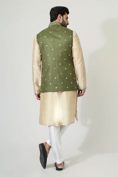 Green sleeveless bundi with mirror, thread embroidery in floral pattern. Paired with beige full sleeve embroidered kurta and pant. - Aza Fashions Traditional Sleeveless Kurta With Gota Work, Transitional Sleeveless Cotton Kurta, Spring Wedding Nehru Jacket With Gota Work, Cotton Nehru Jacket With Gota Work For Wedding, Sleeveless Cotton Kurta With Zari Work, Fitted Cotton Nehru Jacket With Gota Work, Traditional Sleeveless Nehru Jacket For Festivals, Sleeveless Cotton Traditional Wear For Festivals, Spring Festive Bandhgala With Gota Work