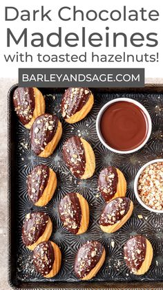 chocolate dipped heart shaped pastries with toasted hazelnuts on a baking sheet