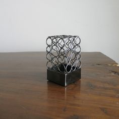 a metal object sitting on top of a wooden table