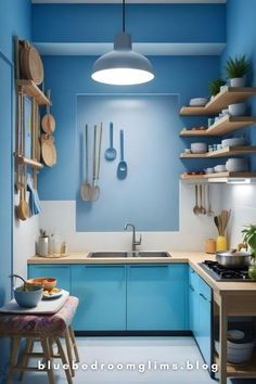 a blue and white kitchen with wooden shelves on the wall, hanging utensils