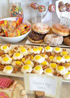 an assortment of doughnuts and pastries on display at a candy buffet table