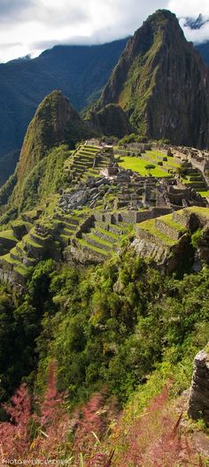 the ruins of machu picchuta are surrounded by lush green vegetation and mountains