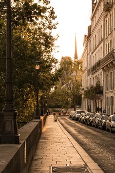 an empty street with cars parked on both sides