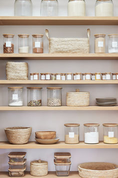 the shelves are filled with baskets and containers