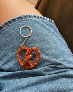 the back of a person's jeans with a keychain in the shape of a heart