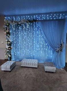 an image of a stage set up for a wedding ceremony with white flowers and blue drapes