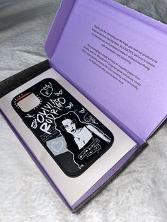 an open purple box with the inside opened and writing on it's front cover