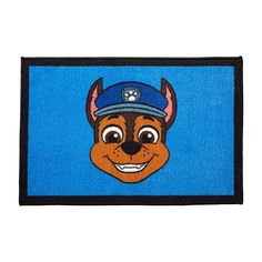 a blue door mat with a cartoon dog wearing a baseball cap on it's head