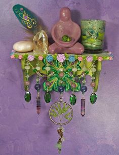 a purple wall with a green and pink clock hanging from it's side next to other items