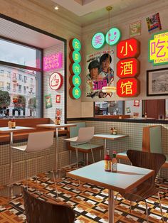 the interior of a fast food restaurant with neon signs on the wall and tiled floor