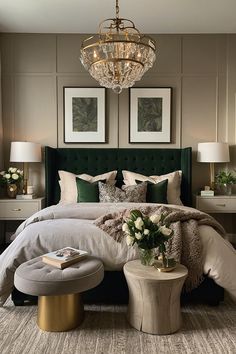 a bedroom with a green headboard and chandelier above the bed is decorated in neutral tones