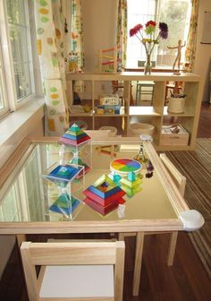 a glass table topped with lots of colorful blocks