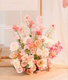 a vase filled with lots of pink and white flowers