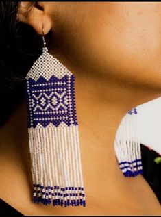 a close up of a person wearing some kind of earring with beads on it