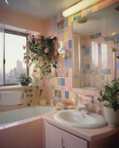 a bathroom with pink and blue tiles on the wall, tub, sink and window