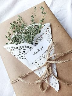 an envelope wrapped in brown paper and tied with twine