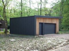 two garages in the middle of a wooded area with one door open and another closed