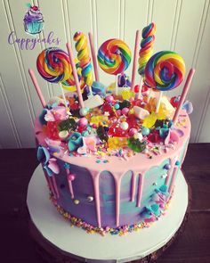 a birthday cake decorated with candies and lollipops