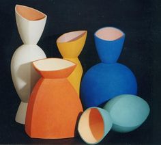 several different colored vases sitting next to each other