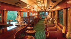 the inside of a train car with many chairs and tables