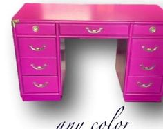 an image of a pink desk with gold handles