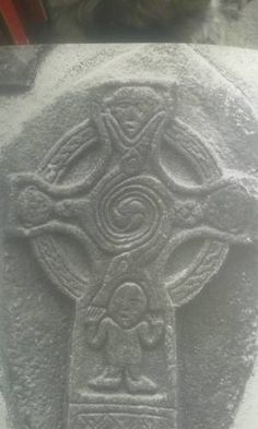 a stone with a cross carved into it