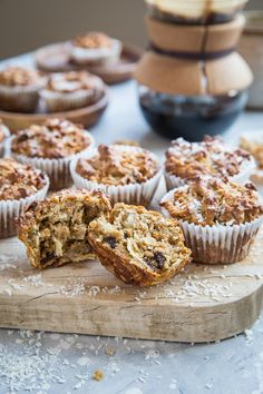 muffins on a cutting board with one cut in half and the other partially eaten