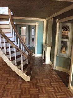 the inside of a house with wood floors and stairs