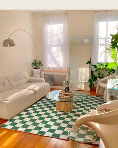 a living room with green and white checkered rugs on the wooden flooring