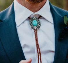 This awesome bolo tie has a southwestern design and agate centerpiece. The cord is genuine brown leather.Our bolos pair nicely with many of our belt buckles! They make wonderful gifts. The western bolo tie rope length is 39'' ; charm agate stone pendant size is 2'' x 1 1 /2'' Men’s Bolo Tie Wedding, Western Bow Tie, Western Bolo Ties With Adjustable Length For Western-themed Events, Western Bolo Ties For Western-themed Events, Concho Lariat Bolo Tie For Western-themed Events, Concho Bolo Ties For Western-themed Events, Lariat Bolo Tie With Adjustable Length For Western-themed Events, Western Lariat Bolo Ties For Western-themed Events, Formal Brown Concho Jewelry