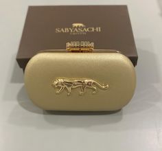 Sabyasachi inspired clutches available in different colors to enhance your attire! It is perfect for casual and party wear with a long metal chain. Every item is double checked for quality before being shipped out. Size: 7.5 L x 2 W x 4.5 H inches approx. Normal size phones easily fit into these clutches. We ship out within 2 -3 days of receiving the order. We will ship out within 24 hours upon request. If you have any questions, please do message us and we will respond back. Packaging: We offer Designer Silver Clutch As A Gift, Silver Chic Clutch For Gift, Silver Chic Clutch As A Gift, Chic Silver Clutch For Gift, Luxury Clutch For Wedding Guest, Luxury Openable Clutch As A Gift, Luxury Openable Clutch For Gift, Designer Gold Clutch For Formal Events, Designer Gold Clutch For Formal Occasions