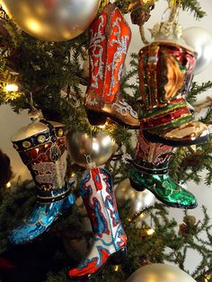 a christmas tree with ornaments hanging from it's branches and an ornament in the shape of boots