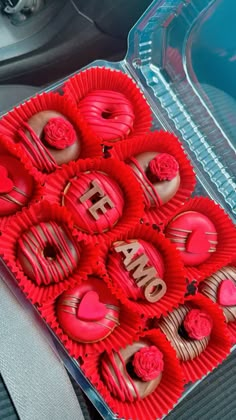 there are many heart shaped chocolates in the box on the car seat belter