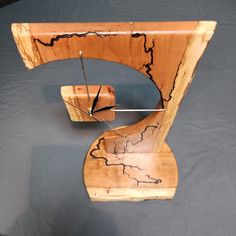 a clock made out of wood on top of a table