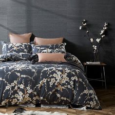 a bed with black and white flowers on it