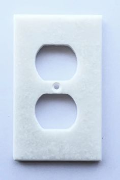 an electrical outlet cover on a white surface