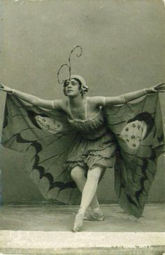 an old photo of a woman with a butterfly costume