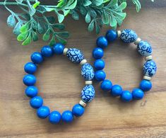 Such gorgeous shades of royal blue wood beads paired with floral blue and white ceramic chinoiserie beads.  Bracelet measures appropriately 7.5 or 8 inches. Message me if you need a different size! Thanks so much for stopping by Beaded Blues! Blue Wooden Beaded Bracelets As Gift, Adjustable Blue Beaded Bracelets With Wooden Beads, Adjustable Blue Stretch Bracelet With Wooden Beads, Blue Stretch Bracelet With Round Wooden Beads, Blue Wooden Beads Stretch Bracelet, Blue Wooden Beads Stretch Bracelet As Gift, West Lafayette, Blue Chinoiserie, Blue Beaded Bracelets