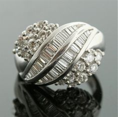 Vintage Platinum RingVintage decadence!  This sparkling platinum ring is just covered with diamonds...you get a lovely mixture of both rounds and baguettes.  Clean and elegant!VintagePlatinum2.5 cts Total WeightSize 5 (Sizable*)Please read through shop policies prior to purchase. Thank you for looking and please contact us with any questions!*No exchanges will be accepted if the ring is sized/altered in any way Platinum Cluster Diamond Ring With Baguette Diamonds, Platinum Cluster Rings With Baguette Diamonds, Elegant Cluster Diamond Ring With Baguette Diamonds, Elegant Cluster Baguette Diamond Ring, Elegant Baguette Diamond Cluster Ring, Silver Cluster Diamond Ring With Baguette Diamonds, Vintage Platinum Rings, Vintage Engagement Rings Simple, Platinum Diamond Ring