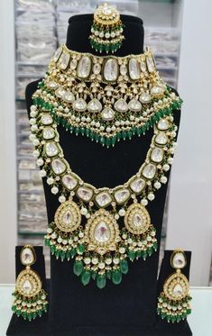 an elaborate necklace and earring set on display