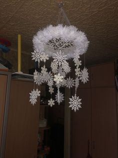 a chandelier with snowflakes hanging from the ceiling