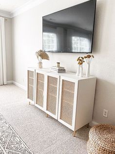 a living room with a large flat screen tv on the wall