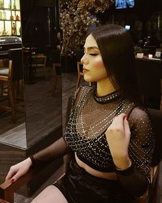 a mannequin is sitting in front of a glass display case at a restaurant