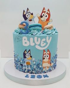 a blue cake with cartoon characters on it