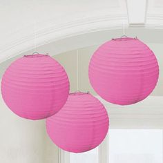 three pink paper lanterns hanging from the ceiling